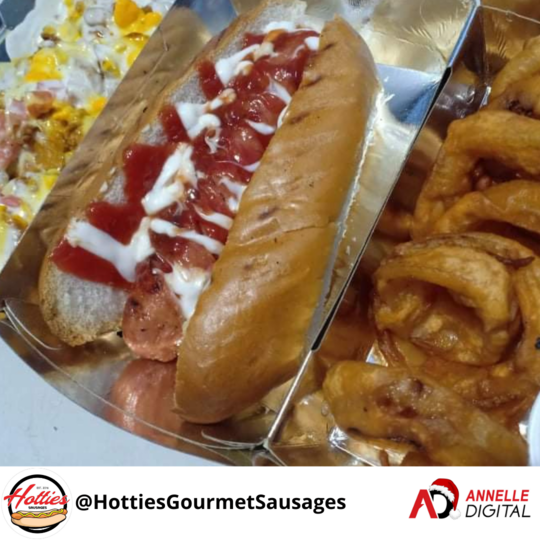 Sausage in a bun with extra relish on the side and onion rings from Hotties Gourmet Sausages